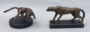 sculpture of pair of bronze cheetahs mounted on slate