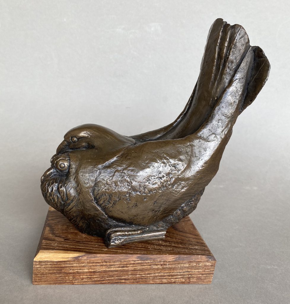 Bronze sculpture of a brooding pigeon
