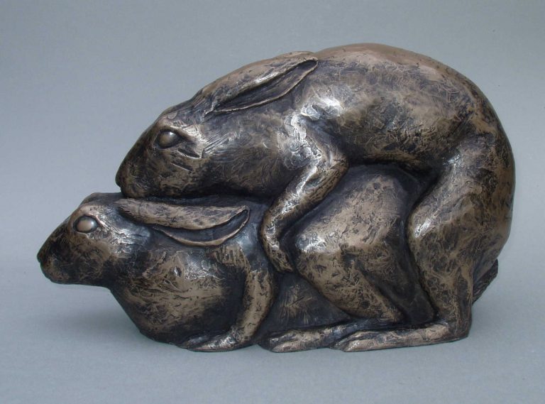 Sculpture of a pair of hares in resin bronze