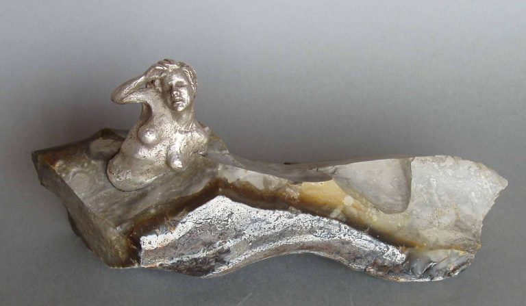sculpture of a silver Venus in a flint stone