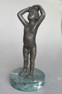 Bronze sculpture of small boy with a sponge