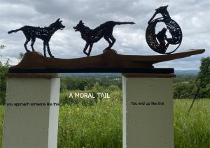 Three dogs sculpture with a moral tail