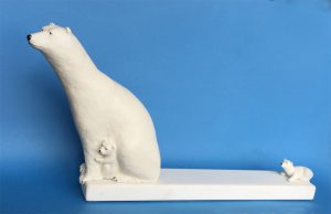 A polar bear with cubs stranded on ice